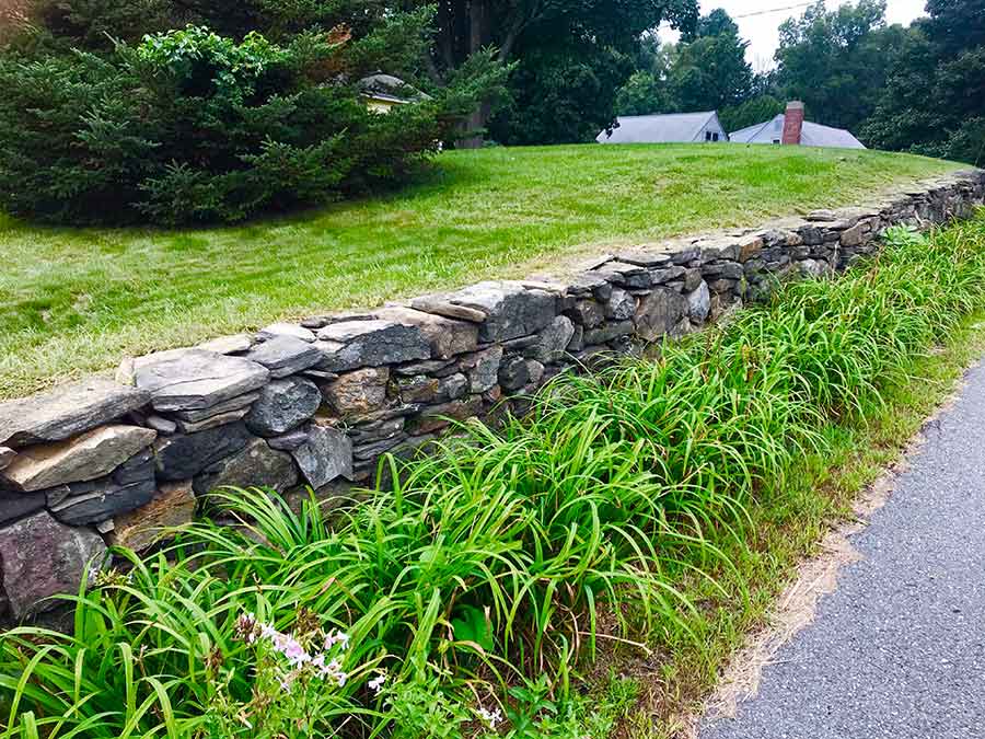 Field stone retaining wall in front yard.