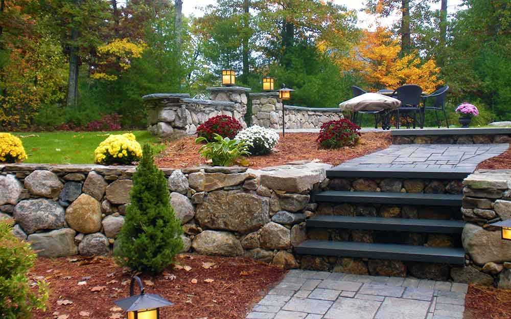 Beautiful natural stone hardscape walkway, steps, patio, and walls.