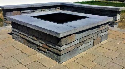 Square outdoor fire pit on patio.