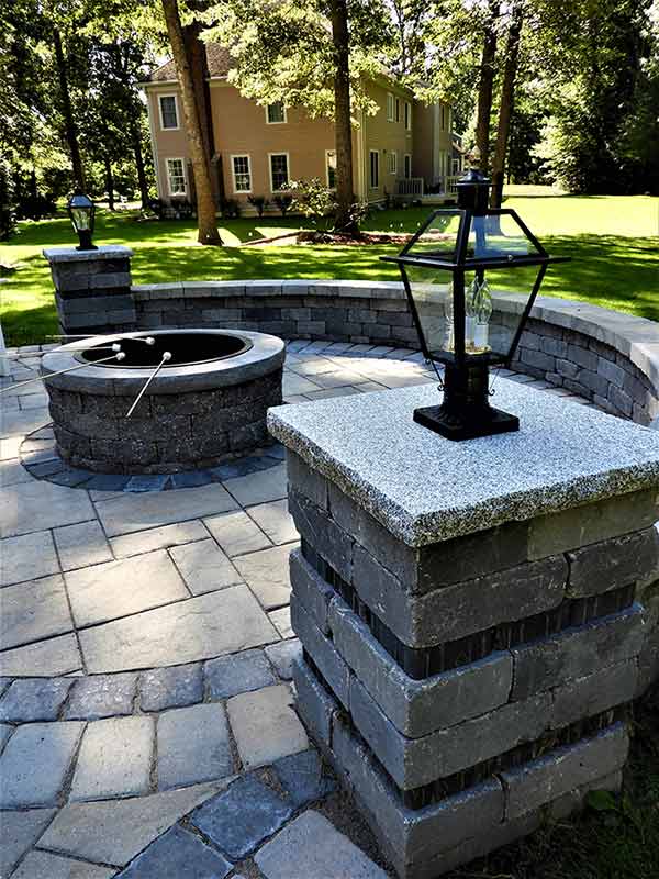 Beautiful outdoor fire pit, patio, and lighting columns.