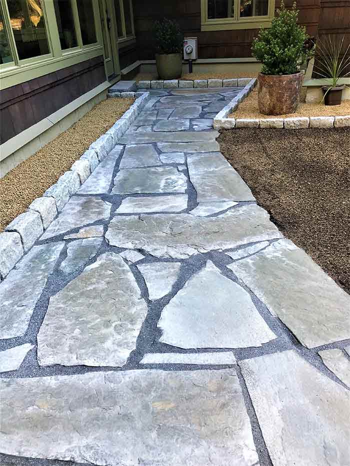 Custom stone walkway on back entrance of home.