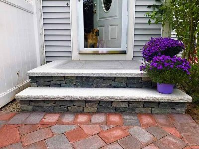 Veneer stone steps with granite treads.