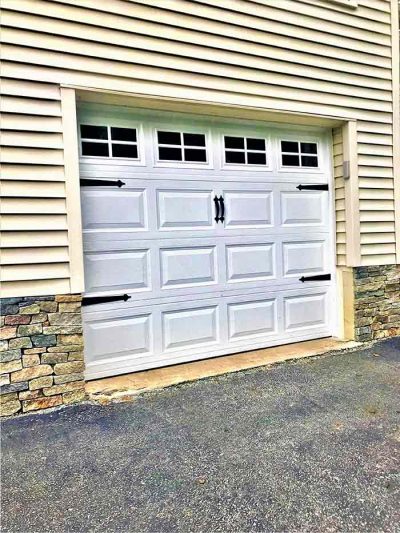 Veneer stone siding on a garage foundation.