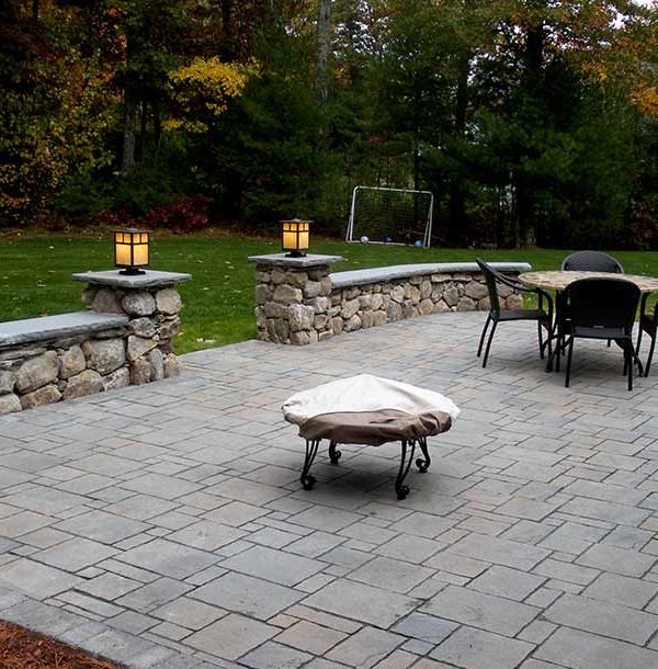 back yard stone patio and retaining walls with lighting