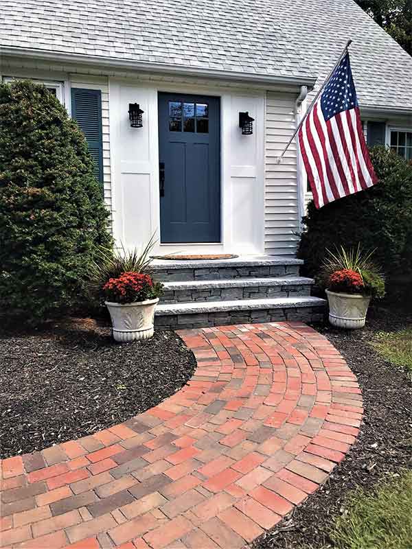 front veneer stone steps with granite treads entryway and brick walkway