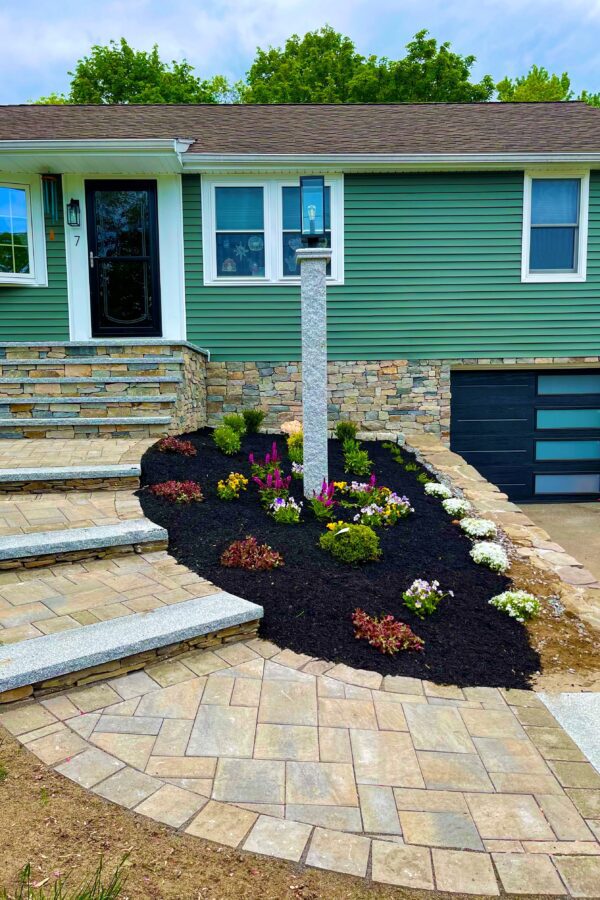 veneer stone foundation with steps and granite capped walkway