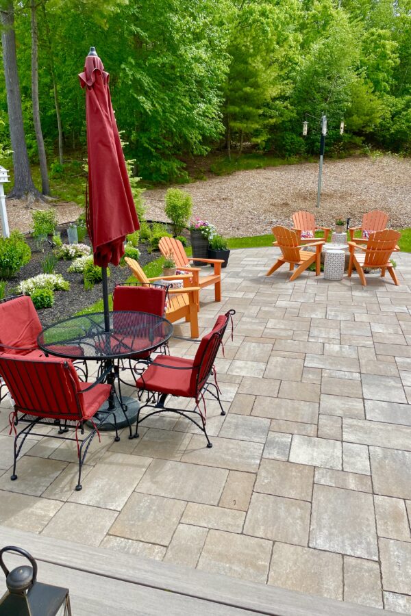 paver patio with natural stone fire pit and furniture for entertaining