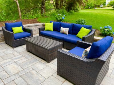 outdoor paver patio with modular block sitting wall and furniture