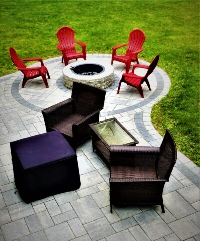 outdoor back yard paver patio with circular fire pit