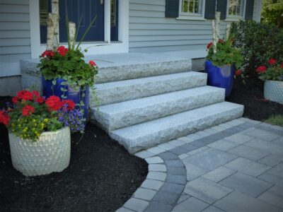 granite front entryway with paver walkway
