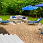 back yard paver patio with granite steps and furniture