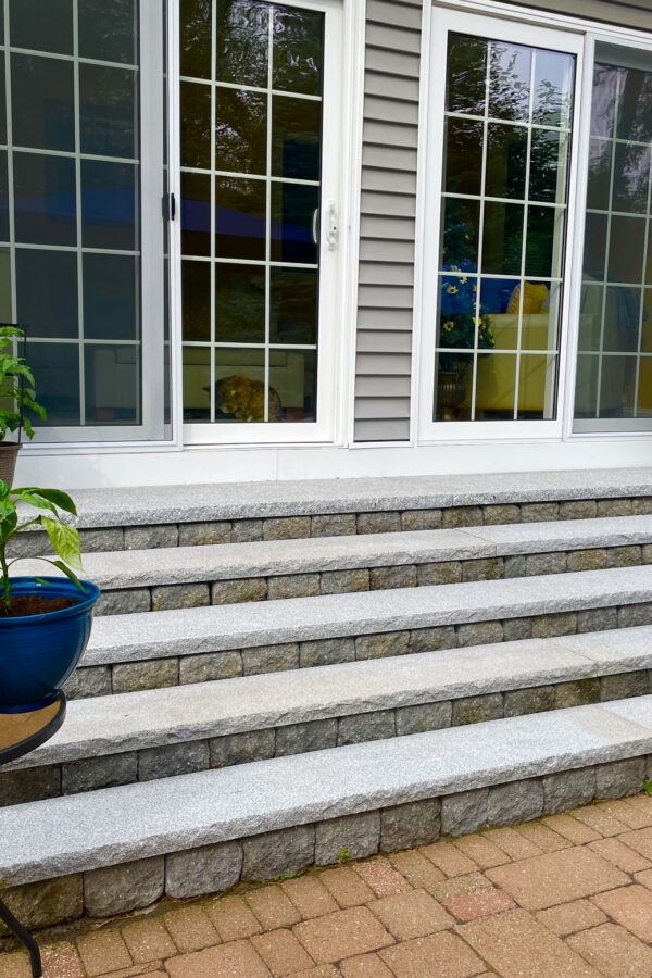 modular block steps with granite treads on back yard paver patio