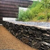 back yard veneer stone retaining wall with crushed stone