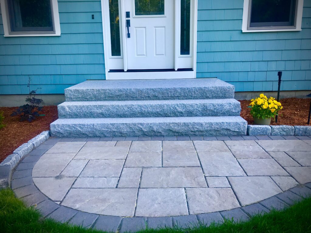 front paver walkway with granite steps and cobblestone bordered planting beds