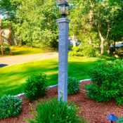 front yard granite lamp post in planting bed