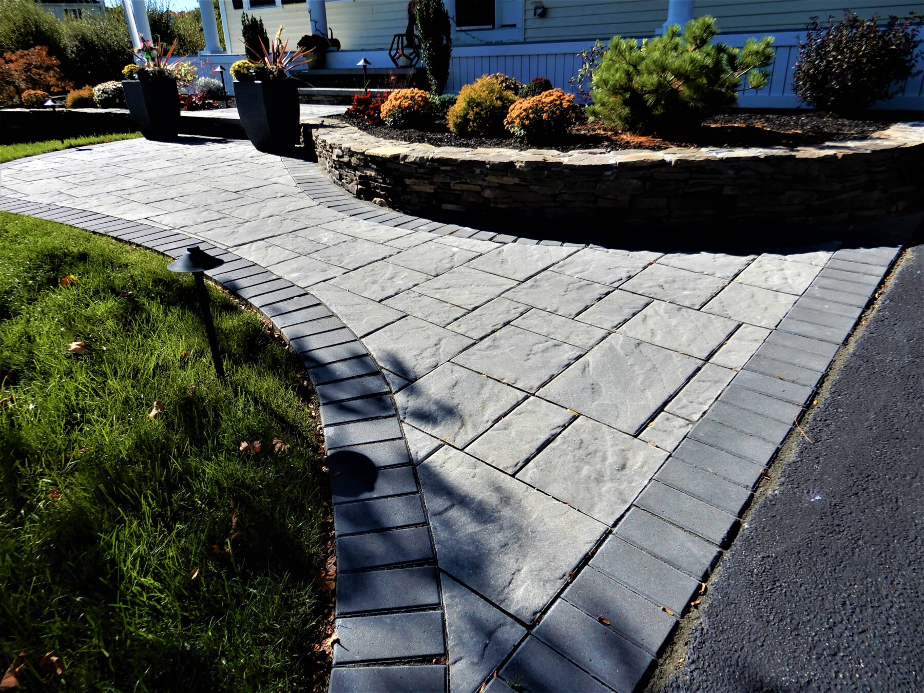 front paver walkway with border and veneer stone planting bed