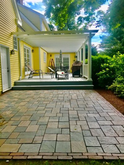 side home paver patio and trellis