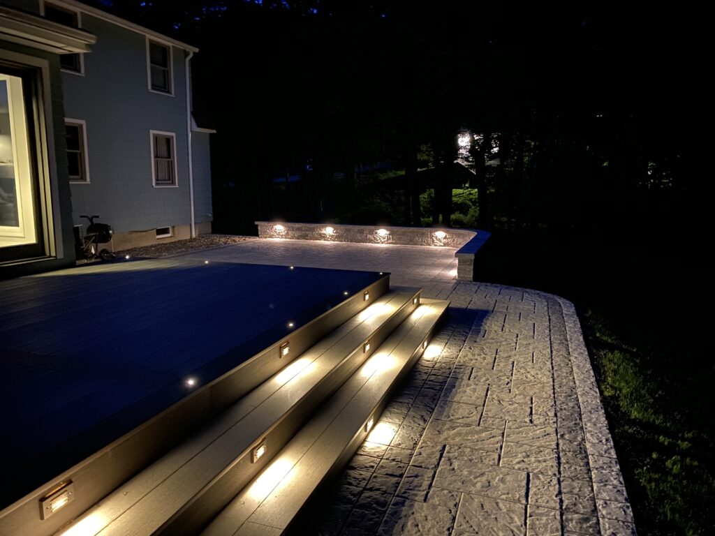paver patio and retaining wall with lighting