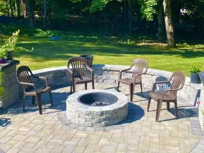 outdoor paver patio with sitting wall and fire pit for entertaining