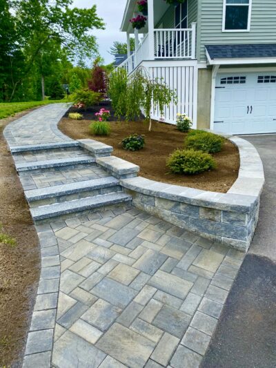 front paver walkway with steps and retaining wall