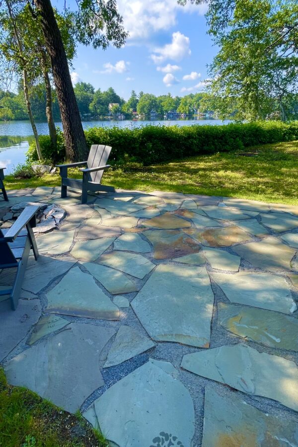 back yard stone patio with fire pit and Adirondack chairs