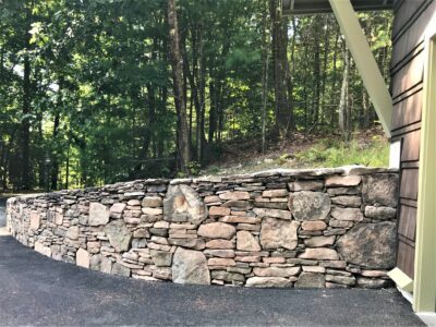 natural stone wall on side of garage