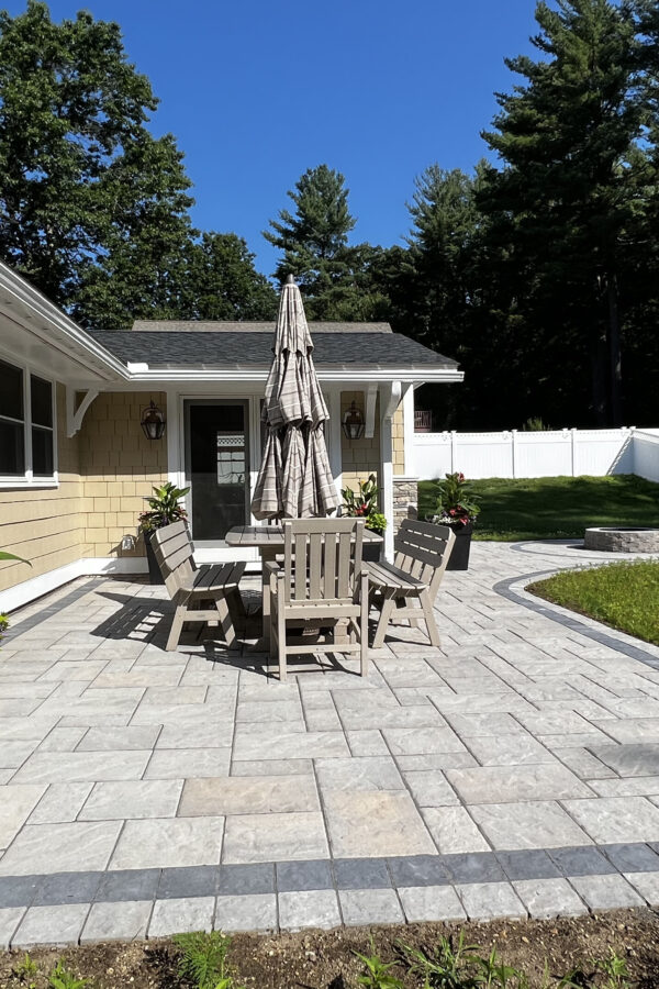 paver patio in back yard with fire pit