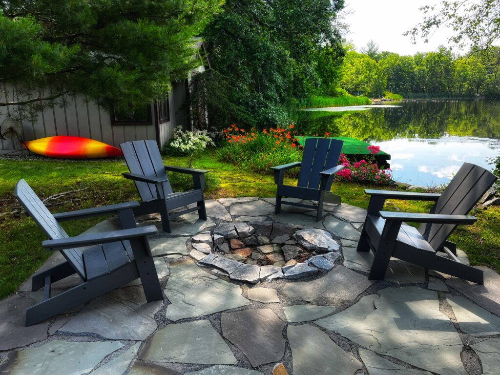 back yard stone patio with natural fire pit