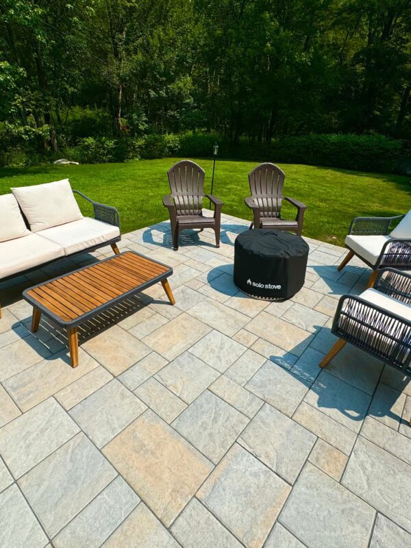 summer outdoor entertaining bluestone patio with fire pit and furniture