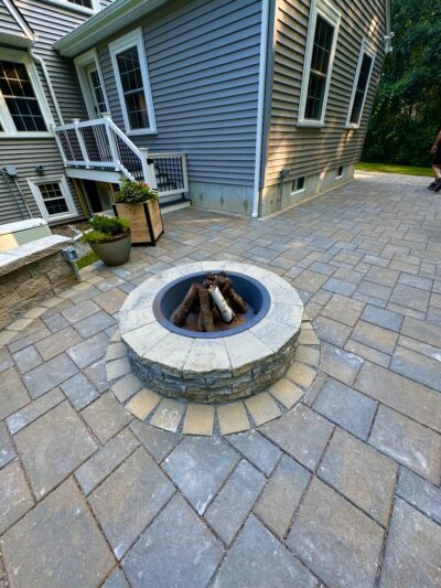 paver patio with modular block sitting wall and fire pit for outdoor entertaining