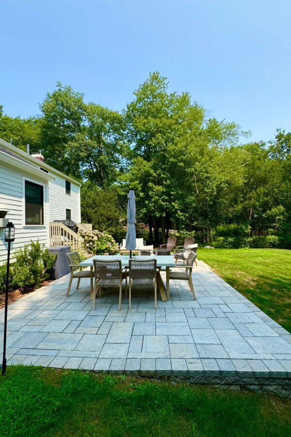 back yard paver patio with fire pit and lawn furniture for outdoor solutions