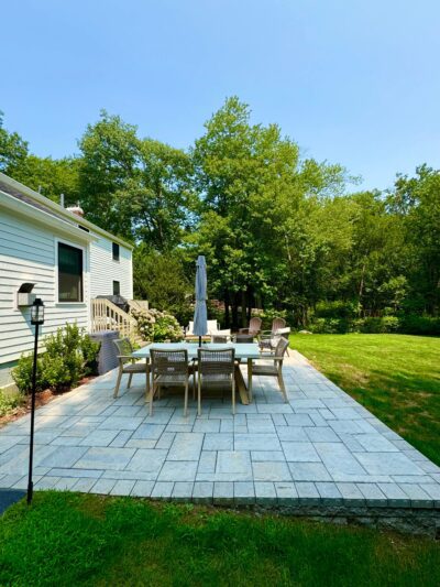 outdoor patio with border and fire pit with table and furniture