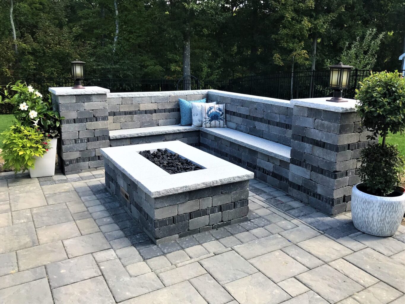 back yard paver patio with sitting wall and fire pit
