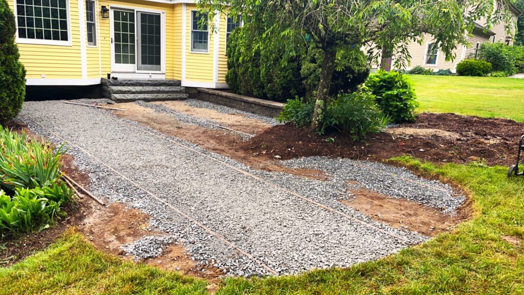 outdoor before picture of backyard paver patio and granite steps