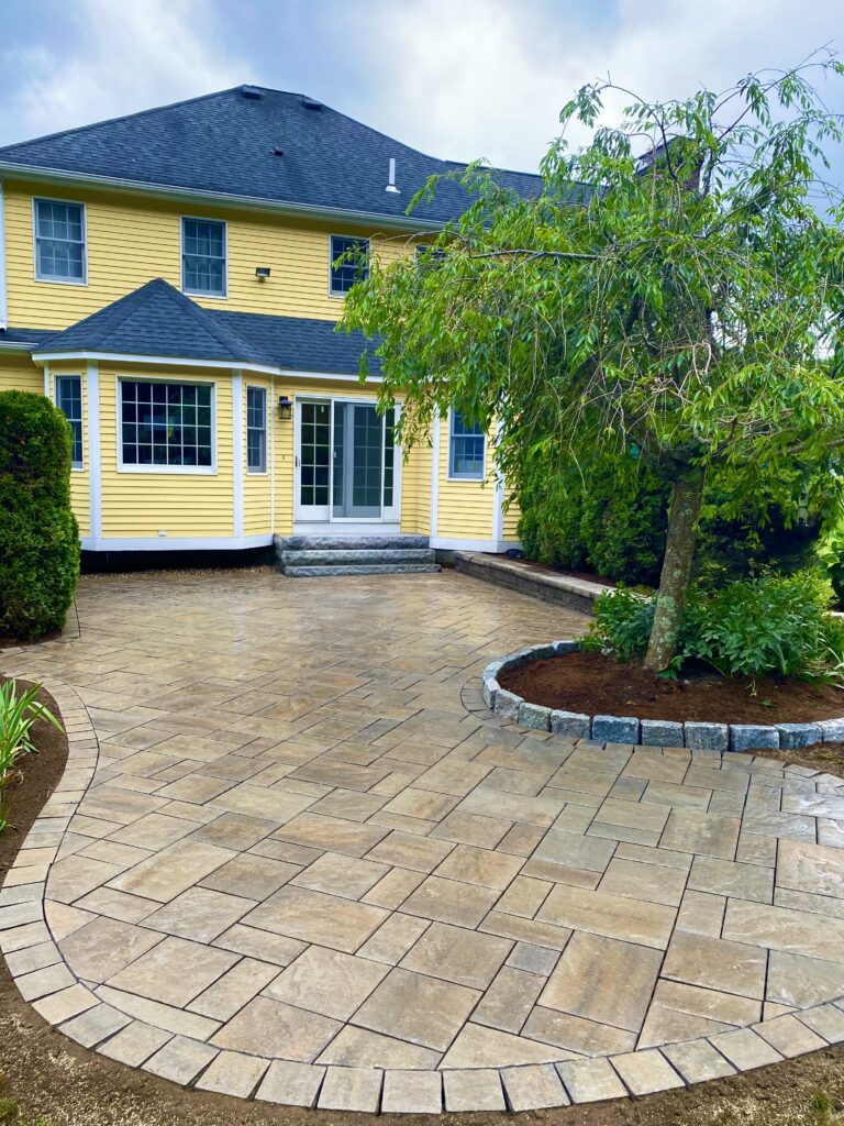 outdoor paver patio with granite steps and cobblestone border
