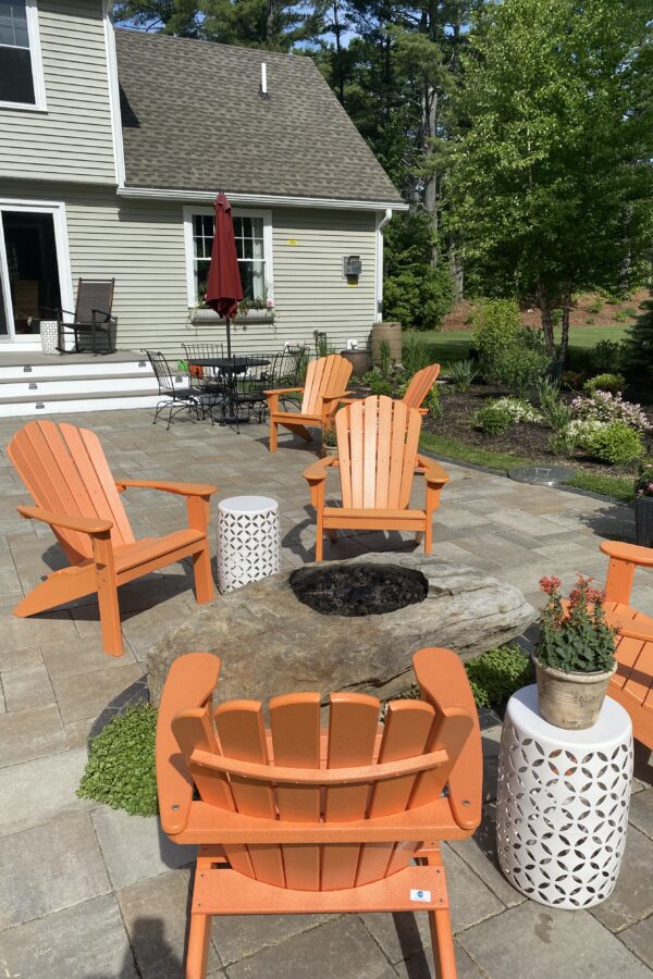 outdoor hardscape designed paver patio with stone fire pit