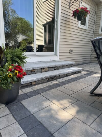 outdoor granite and veneer stone steps on paver patio
